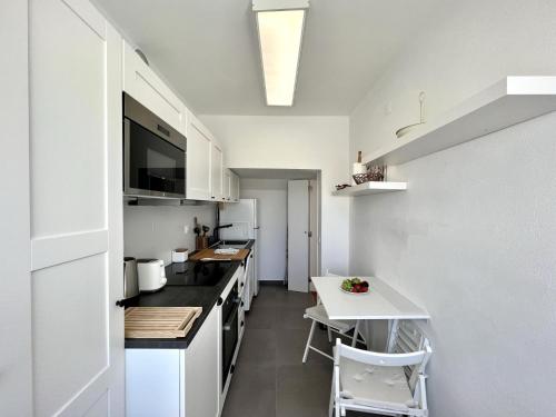 a kitchen with a counter and a table in it at Lagos Ocean Breeze by Homing in Lagos