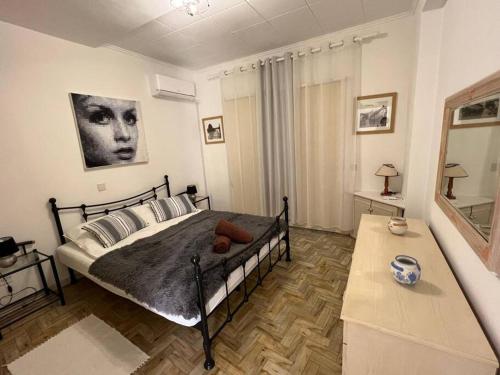 a bedroom with a large bed and a table at The Best prime location lovely 1 bedroom apartment in Paphos City