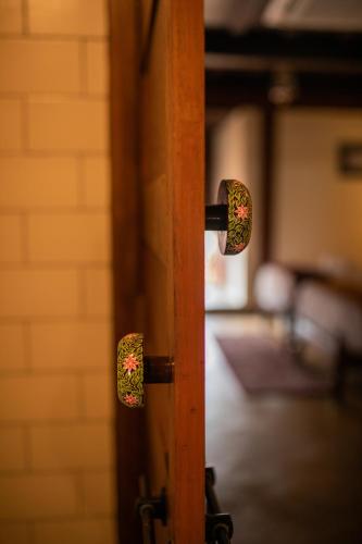 a close up of a door knob on a door at Sawantwadi Palace Boutique Art Hotel in Sawantwadi