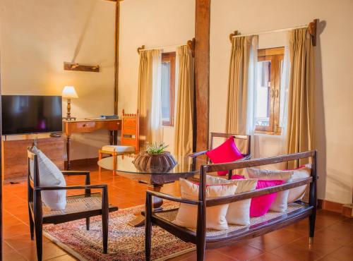 a living room with a couch and a table at Sawantwadi Palace Boutique Art Hotel in Sawantwadi