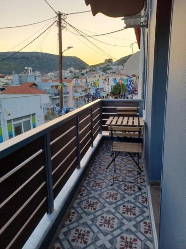 a balcony with a bench and a view of a city at Luxury Apartment with balcony in Mytilini
