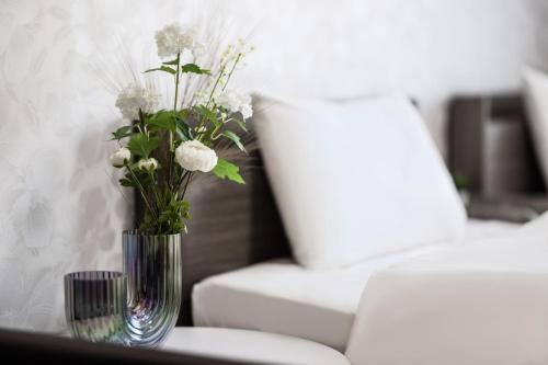 a vase filled with white flowers sitting on a table at Seiryu Tsutenkaku in Osaka