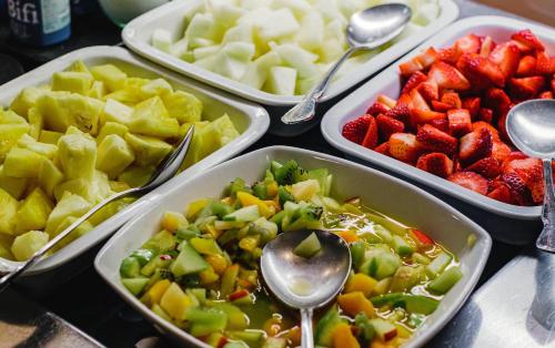 a table topped with four trays of fruits and vegetables at Maisonnave in Pamplona
