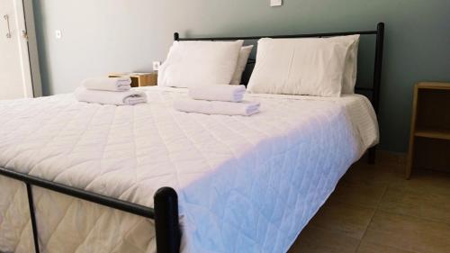 a bedroom with a large bed with towels on it at Aelia Boutique Apartments in Argostoli