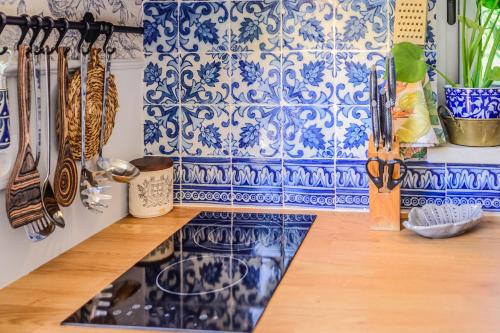 a kitchen with blue and white tiles on the wall at Tennis Club House in Cascais