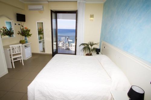 a bedroom with a bed and a view of the ocean at Pescasubacquea in Crotone