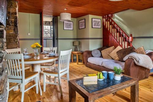 a living room with a couch and a table at Finest Retreats - Maes Neuadd in Blaenau-Ffestiniog