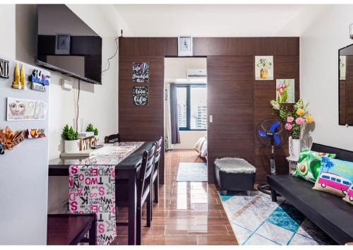 a kitchen and living room with a table and chairs at Marivic's Place in Manila