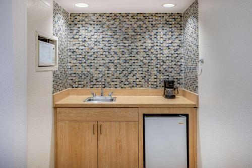 a kitchen with a sink and a tiled wall at Hotel Carolina A Days Inn by Wyndham in Hilton Head Island