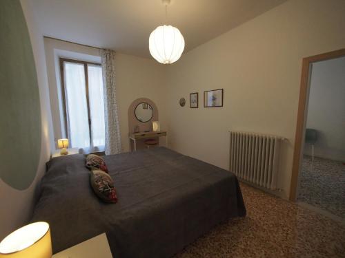 a bedroom with a large bed and a large window at From Pedrotti in Desenzano del Garda
