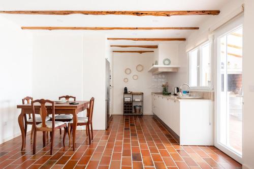 a kitchen with a table and chairs in a room at WHome Countryside Charm Near Wedding Venue w/ BBQ Patio in Torres Vedras