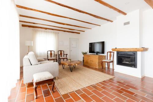a living room with a couch and a fireplace at WHome Countryside Charm Near Wedding Venue w/ BBQ Patio in Torres Vedras