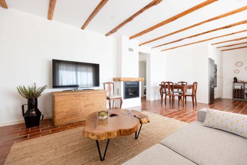 a living room with a table and a dining room at WHome Countryside Charm Near Wedding Venue w/ BBQ Patio in Torres Vedras