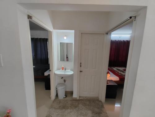 a bathroom with a sink and a toilet and a bed at NK Homes -Serviced Apartments - 2 BHK Homestay, Fast Wifi, Fully Furnished in Hyderabad
