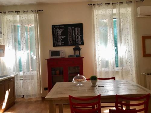 a dining room with a table and chairs and windows at Roma Da Noi Suite in Rome