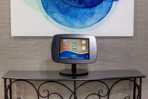 a small tv sitting on a table in front of a wall at Baymont by Wyndham La Vergne Nashville I-24 East in La Vergne