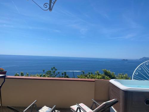 a balcony with chairs and a view of the ocean at Il Profumo dei Fiori in Praiano
