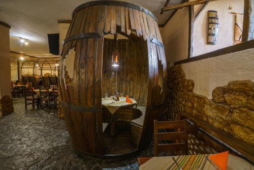 a room with a large wooden mirror in a restaurant at Troyan Plaza Hotel in Troyan