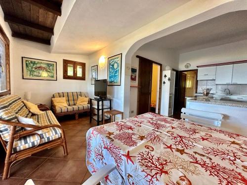 a bedroom with a bed and a living room at Residence Domos De Rocca in Monte Petrosu