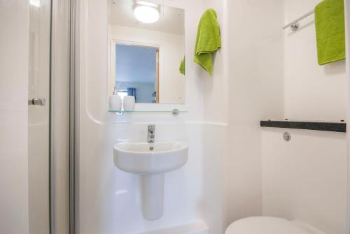 a white bathroom with a sink and a toilet at Beaverbank Place - Campus Residence in Edinburgh