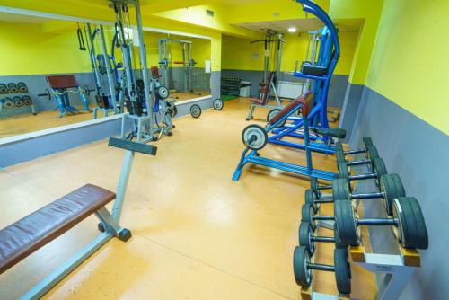 a gym with several exercise equipment in a room at Troyan Plaza Hotel in Troyan