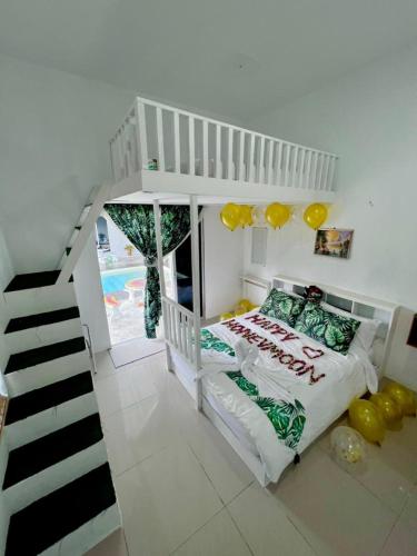 a bedroom with a bunk bed and a staircase at Villa Maya in Kampung Mawar