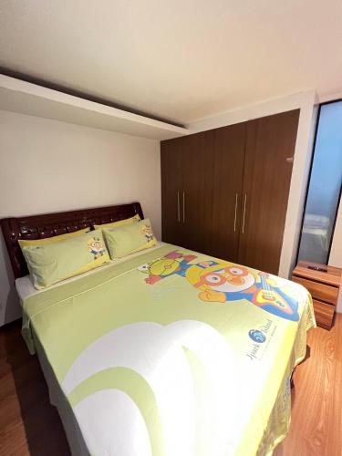 a bedroom with a large bed in a room at Home-like 2BR Unit in the Center in Cebu City