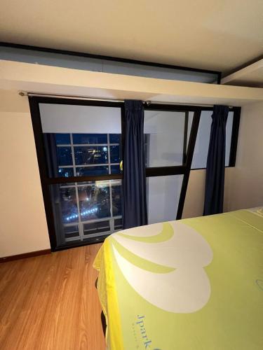 a room with a bed and a large window at Home-like 2BR Unit in the Center in Cebu City
