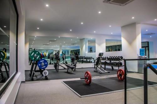 a gym with lots of equipment in a building at Lennox Z in Accra