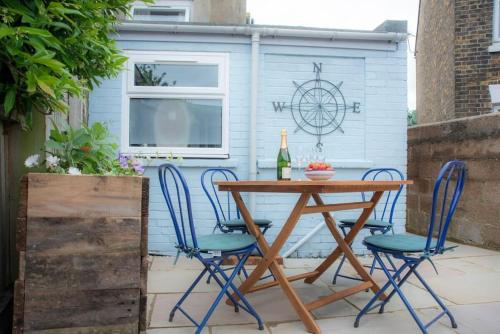 a table and chairs on a patio with a shed at Jewel Pier *2 Bed House* Deal in Deal