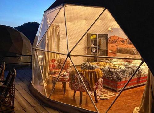 a tent with a bedroom and a bed in it at Hasan Zawaideh Camp in Wadi Rum