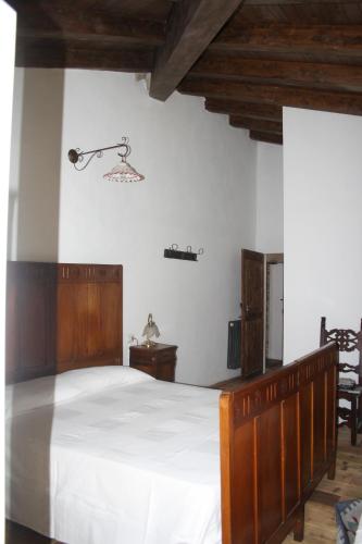 a bedroom with a large bed with white sheets at Ca' Morano in Pavullo nel Frignano