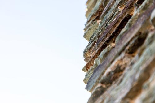 a close up of the side of a brick building at Il Glicine Cala Lupo in Stintino