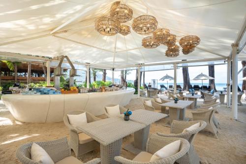 a restaurant with tables and chairs and a bar at InterContinental Phuket Resort by IHG in Kamala Beach