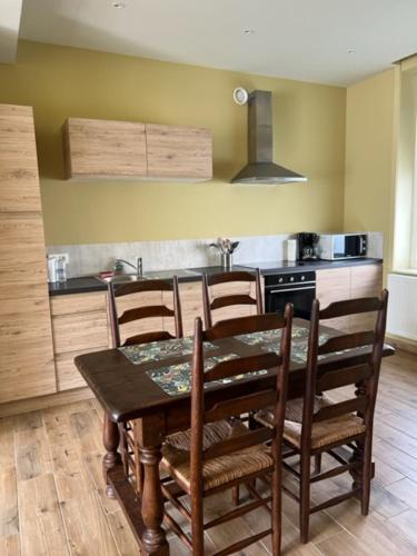 a kitchen with a wooden table and chairs in a kitchen at wante 22 in Bruges