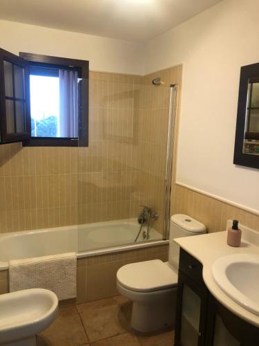 a bathroom with a toilet and a tub and a sink at PLAYA VERDE LUXURY in Ayamonte