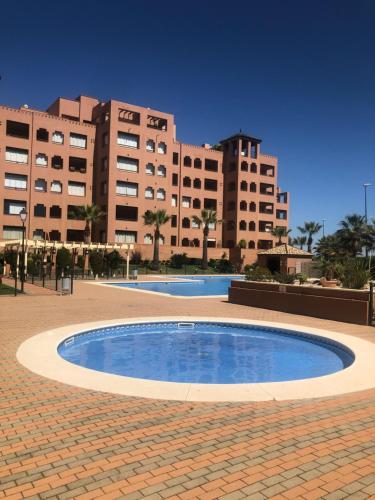 a large swimming pool in front of a large building at PLAYA VERDE LUXURY in Ayamonte