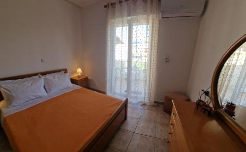 a bedroom with a bed and a large window at Apartment in Tigaki beach Kos in Tigaki