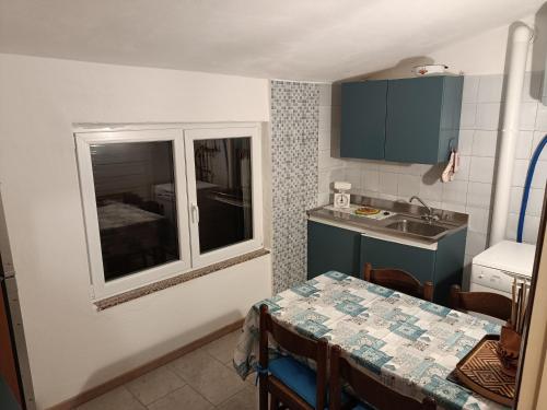 a small kitchen with a table and a window at Ca' Dal Sol in Selvanizza
