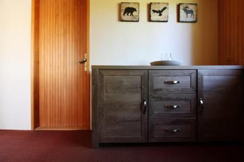 a wooden cabinet with a sink in a room at Vacation house Polane in Delnice