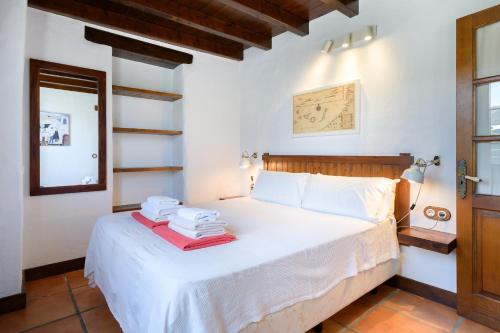 a bedroom with a white bed with towels on it at Casa Amaia II in Tías