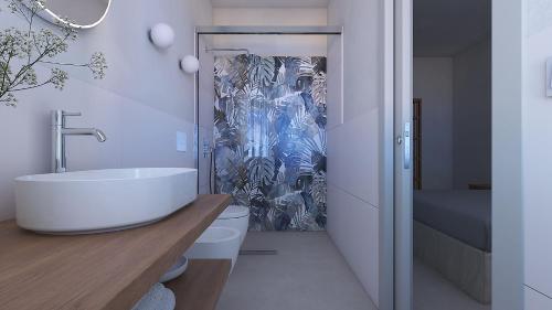a bathroom with a sink and a toilet and a shower at Casa Brì Boutique Rooms in Santa Teresa Gallura