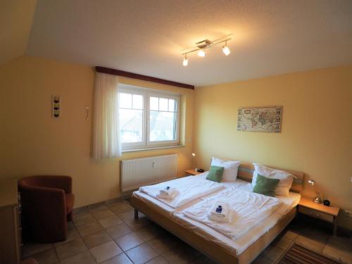 a bedroom with a large bed with a window at Meer, Whg 15 in Zingst