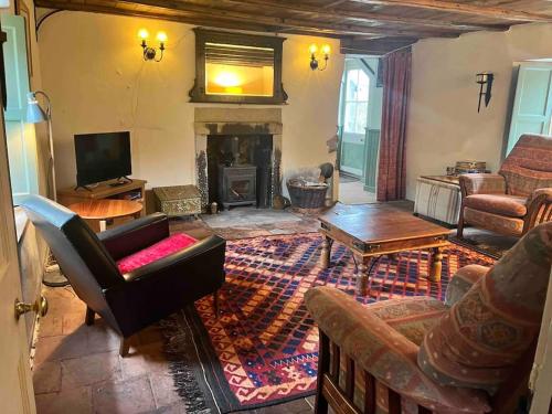 uma sala de estar com mobiliário e uma lareira em Powis House East Cottage em Stirling