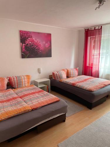 1 dormitorio con 2 camas y ventana en FeWo Zakharov, en Lahr