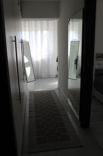 a hallway with two mirrors and a person in the doorway at Vacation house ''CASA TERRA'' in Poreč