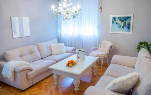 a living room with white couches and a table at Luxe Living in Mostar in Mostar