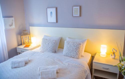 a bedroom with a bed with two white pillows at Luxe Living in Mostar in Mostar