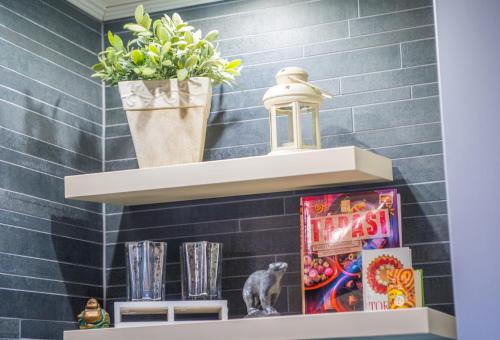 a shelf with a potted plant and books at Luxe Living in Mostar in Mostar