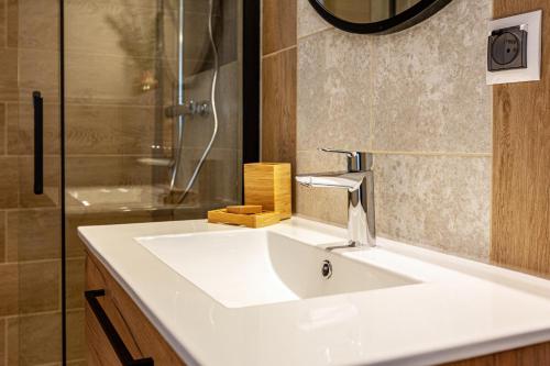 a bathroom with a white sink and a shower at KEJB Chałupy in Chałupy